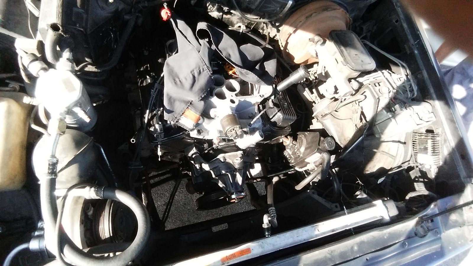 Engine bay mid-repair with components opened up for service